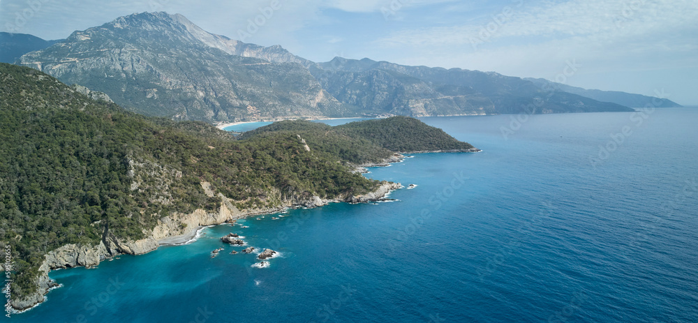 A stunning aerial view of Oludeniz surroundings in Turkey, with sparkling blue sea and tranquil landscape; a peaceful reminder of nature's beauty.