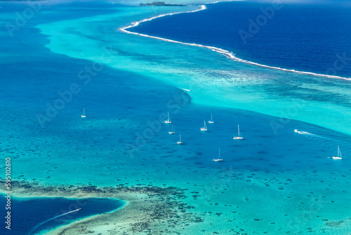 French Polynesia, Raiatea. Aerial view of island's offshore waters with boats.