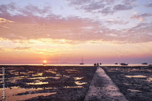 The dramatic gritty sandy landscape of Hat Rai Leh East beach at low tide at sunrise  Railey Bay  Thailand