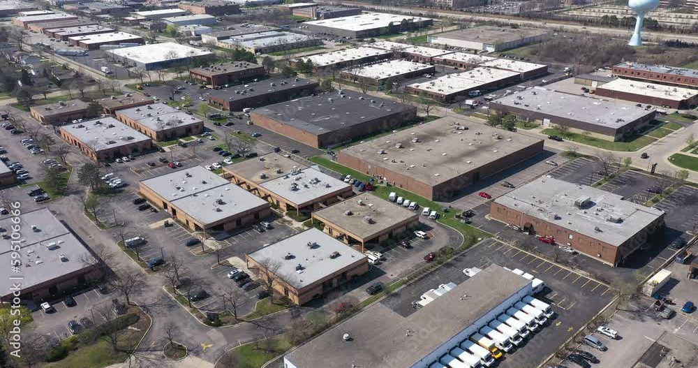 Aerial view of an office park with low-rise buildings near a highway in a suburban setting. Aerial view of an office park with low-rise buildings near a highway in a suburban setting.