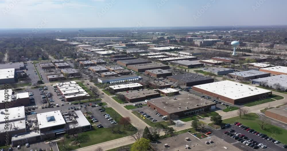 Aerial view of an office park with low-rise buildings near a highway in a suburban setting.