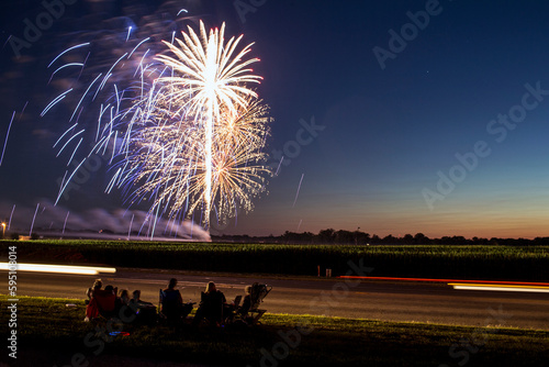 A group of people watching fireworks in a field