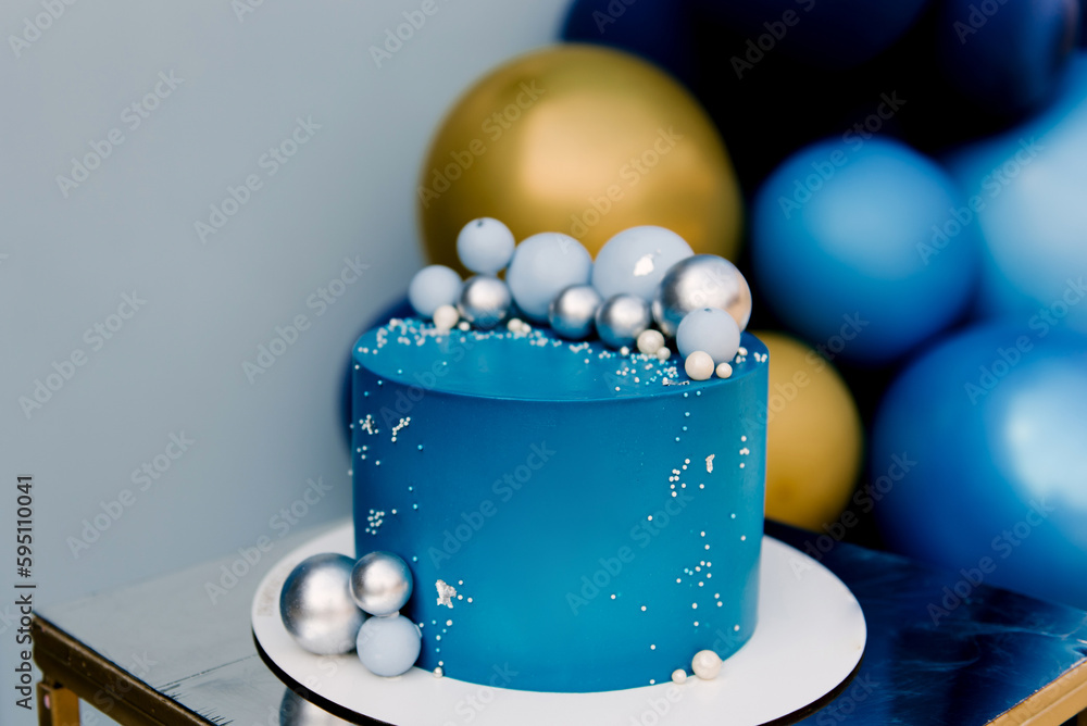 Festive blue cake with balloons design