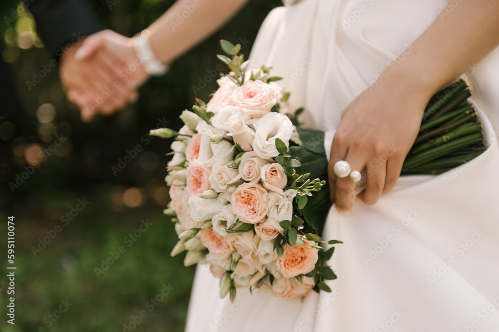 Beautiful wedding bouquet in the hands of the bride Beautiful wedding bouquet in the hands of the bride