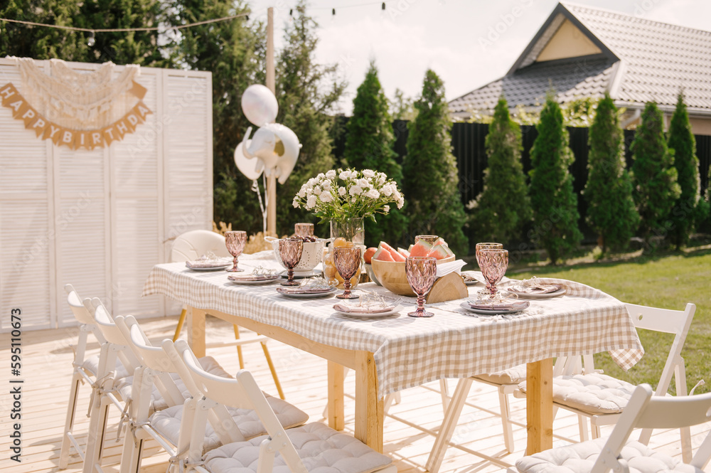 rustic outdoor birthday decor, table setting and photo zone