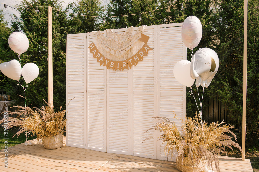 rustic outdoor birthday decor, table setting and photo zone