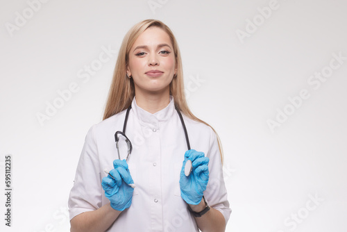 portrait of a beautiful doctor girl on a clean blue background
