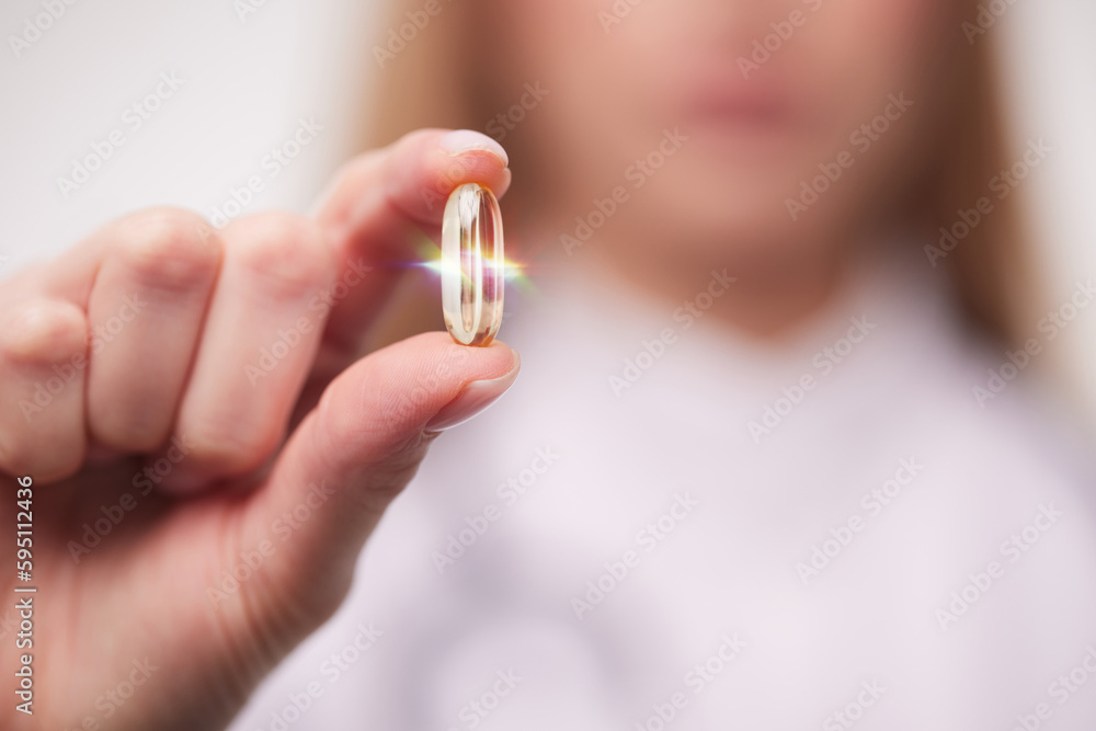 doctor holding a transparent pill in his hands close-up doctor holding a transparent pill in his hands close-up