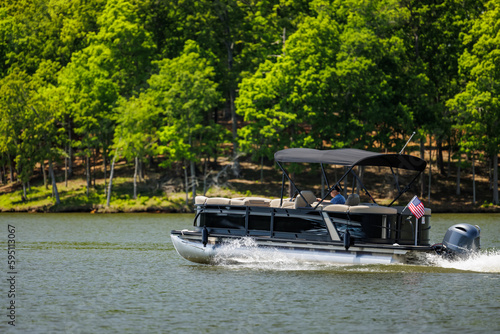 Photos Boater on pontoon boat enjoying summer day on Lake