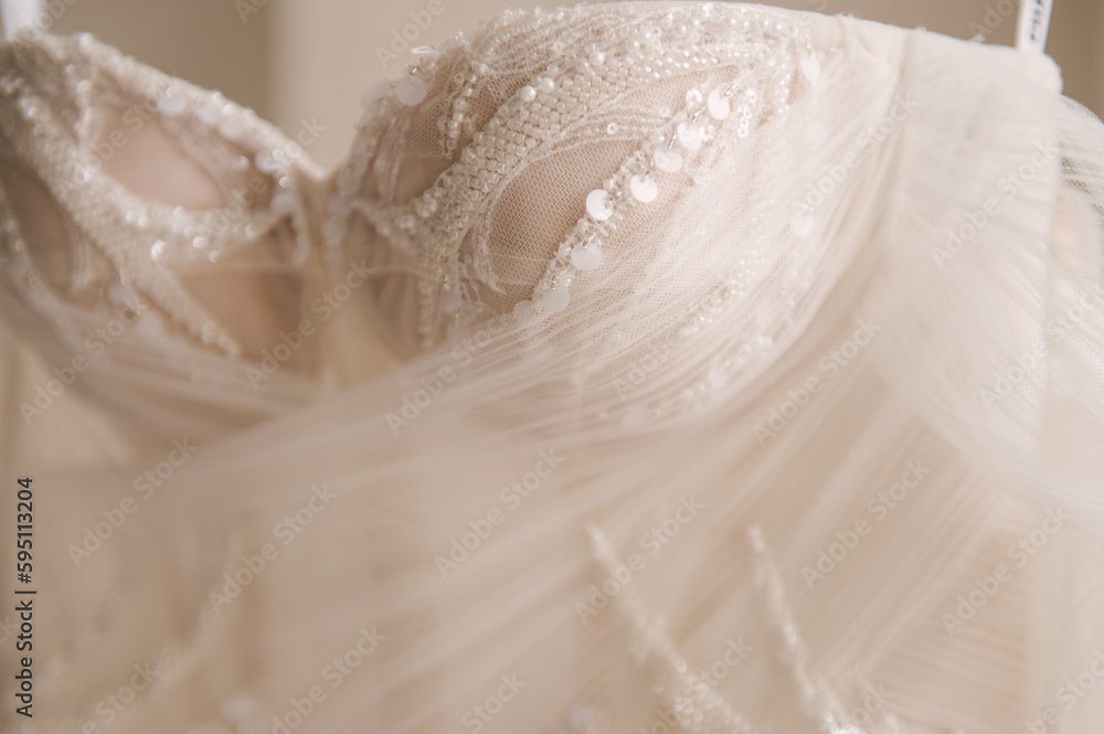 Beautiful delicate luxurious wedding dress of the bride is embroidered with beads, rhinestones and precious stones Beautiful delicate luxurious wedding dress of the bride is embroidered with beads, rhinestones and precious stones