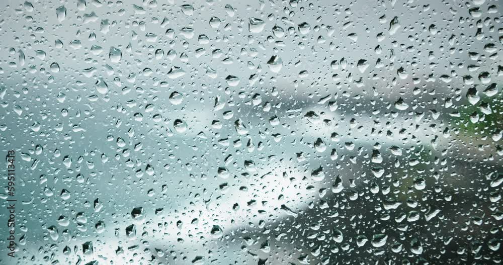 Water drops on transparent window pane during rainy weather. Severe sea crash on rocks outdooors. Stay at home. Calmness and pacification. Water drops on transparent window pane during rainy weather. Severe sea crash on rocks outdooors. Stay at home. Calmness and pacification.