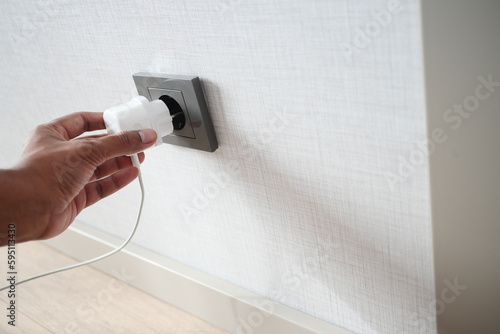 Canvas Print white color power cord cable plugged into wall