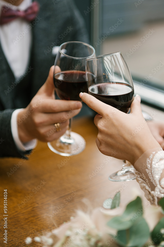 glasses of wine in hands of a couple in love glasses of wine in hands of a couple in love