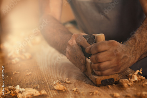 Carpenter Produces golden curls of sawdust © Giulio_Fornasar