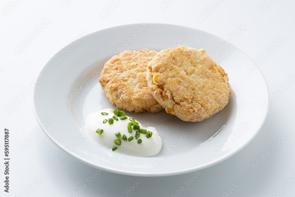 fish cutlet with sour cream on a white background fish cutlet with sour cream on a white background