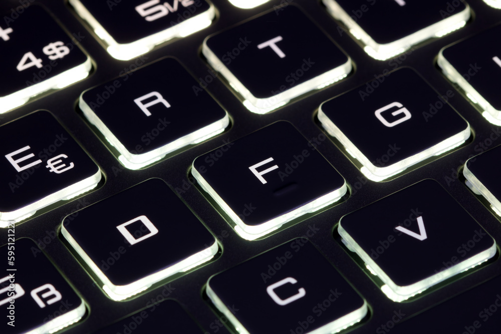 Close-up of laptop keyboard illumination, backlit keyboard