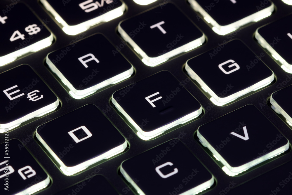 Close-up of laptop keyboard illumination, backlit keyboard Close-up of laptop keyboard illumination, backlit keyboard