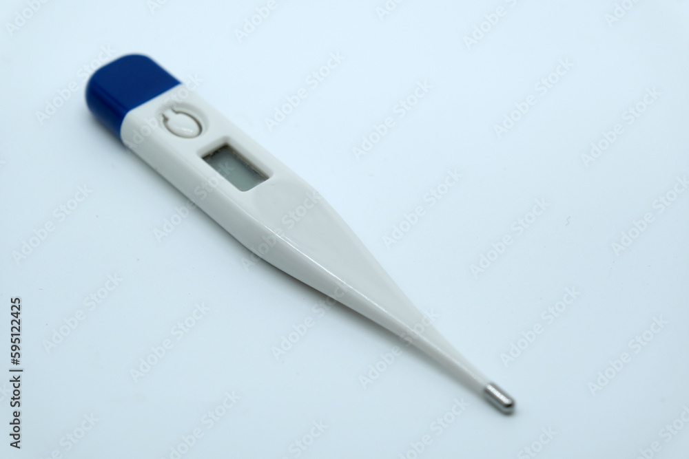 A thermometer with a digital display on a white background A thermometer with a digital display on a white background