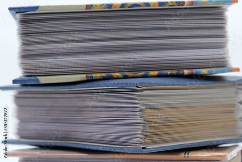 Photo albums stacked on a white background