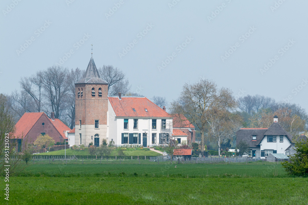  A old traditional Dutch house and church in the village in Holland