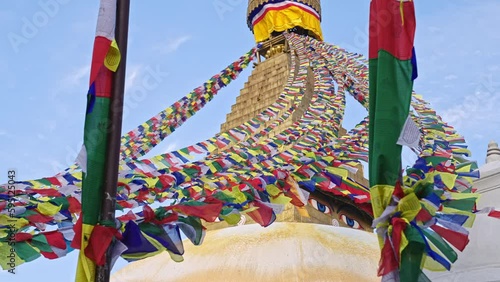 Hundreds of colorful prayer flags blowing with the wind in slow motion at Boudhanath Stupa, Kathmandu, Nepal