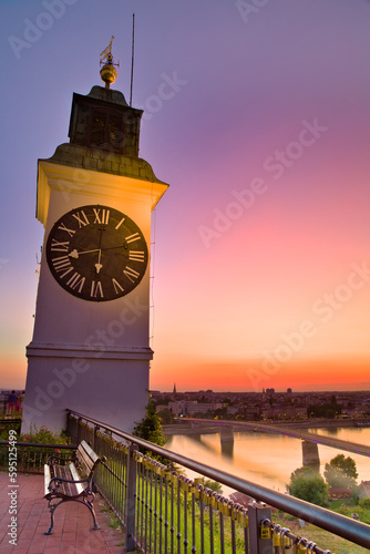 The Petrovaradin Clock Tower in Novi Sad, Vojvodina, captured after sunset, radiates a sense of history and tradition with its ornate details and warm lighting.