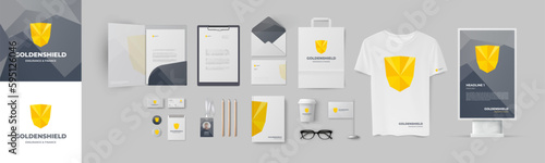 Golden shiled logo corporate identity template design with folder and business card. Business stationery