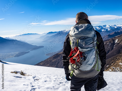 Mountaineer on the alps of Lake Como in winter photo