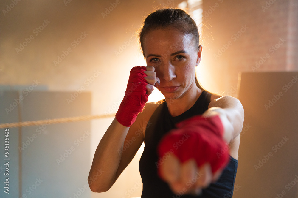 Women self defense girl power. Strong woman fighter punching with red