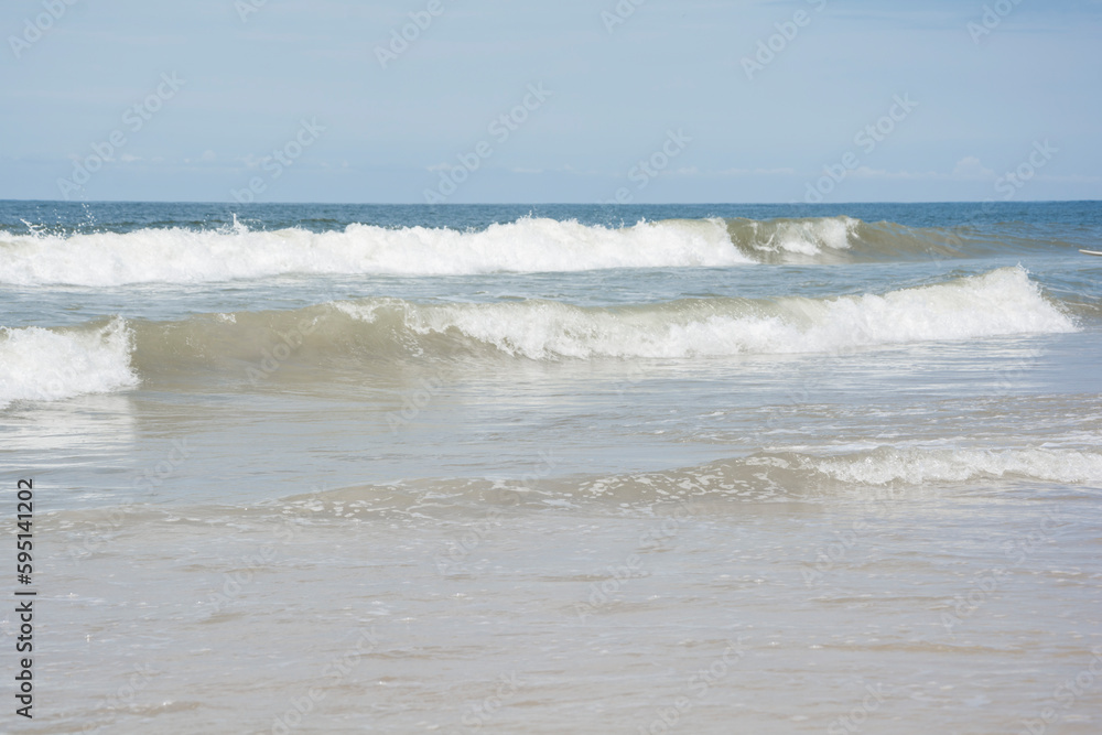 Waves breaking on the shore at the beach