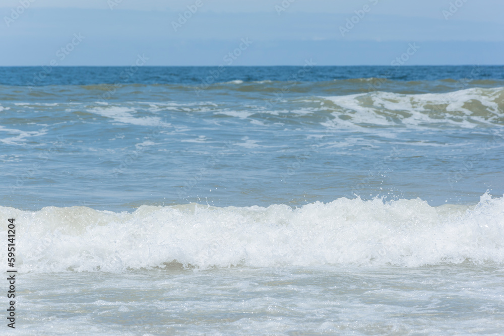 Waves breaking on the shore at the beach Waves breaking on the shore at the beach