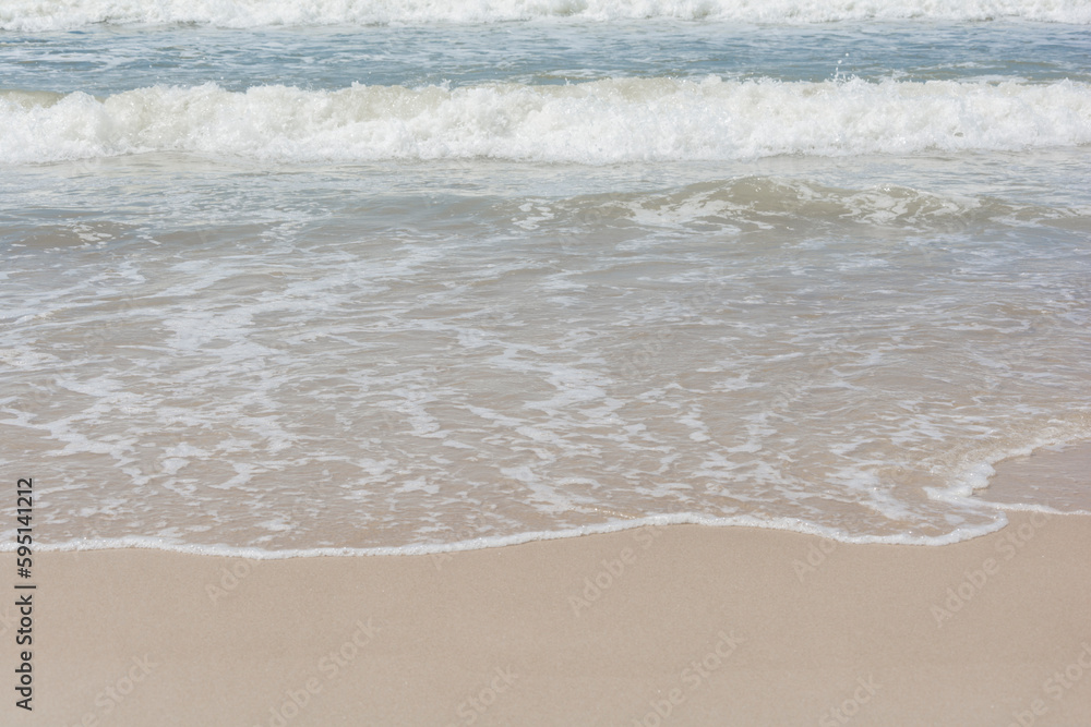 Waves breaking on the shore at the beach