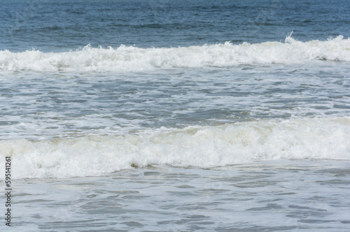 Waves breaking on the shore at the beach © Paula Scavarelli