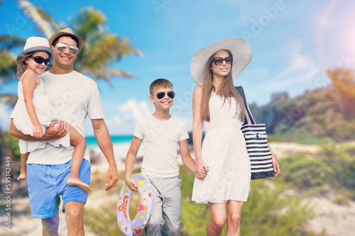 Happy young family having fun in vacation on beach