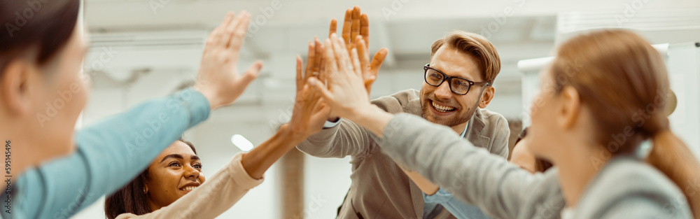 Young team putting hands up for new startup in the office Young team putting hands up for new startup in the office