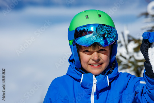 Happiness on the ski hill: young boy in alpine mask portrait