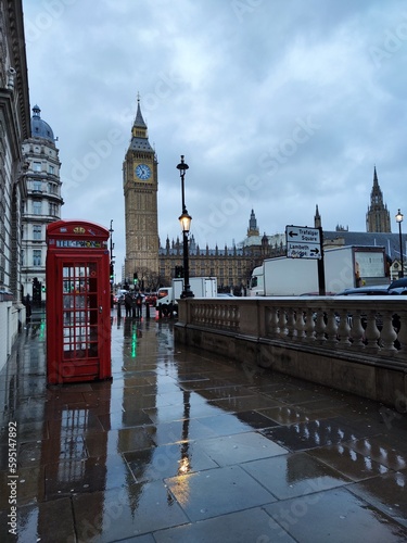 Big Ben, a telephone box and their reflections on a rainy day in London