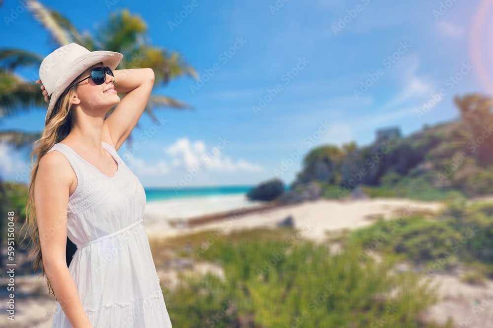 Happy young tourist woman on the beach