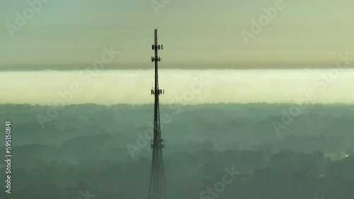 Aerial view of telecommunications cell phone tower with wireless communication 5g antennas for network signal transmission