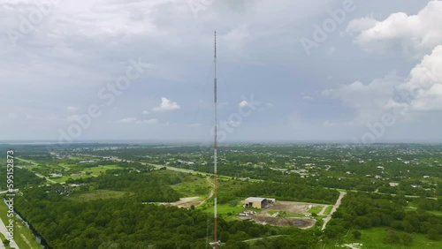 Aerial view of telecommunications cell phone tower with wireless communication 5g antennas for network signal transmission