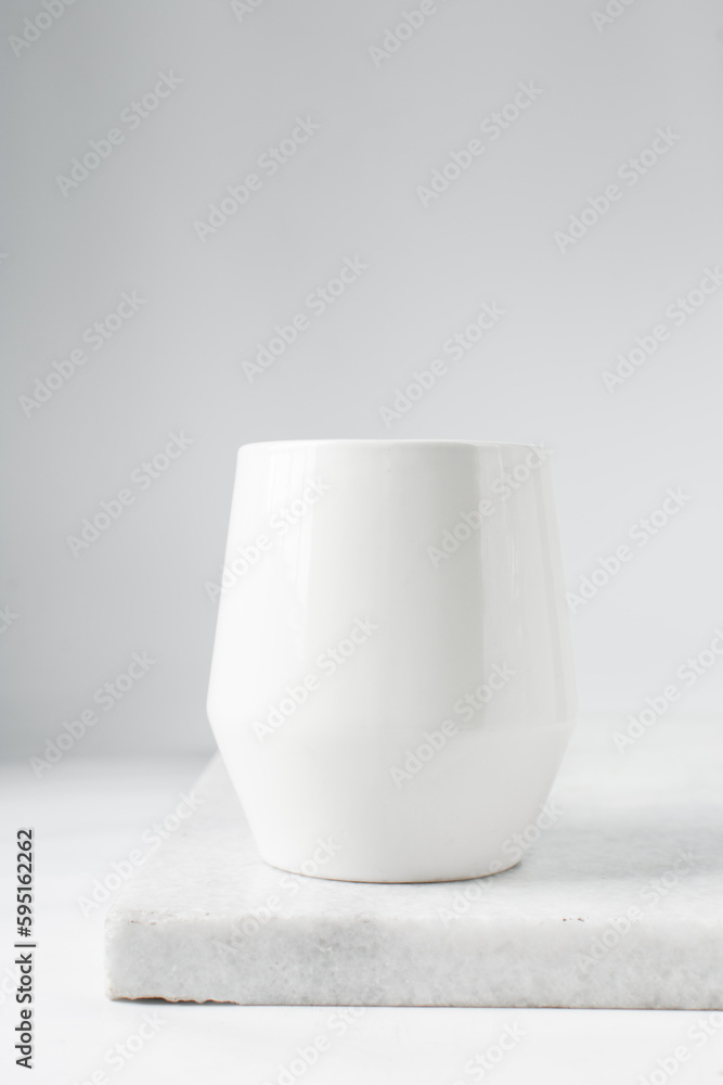 Large white mug on a marble tray, white coffee cup Large white mug on a marble tray, white coffee cup