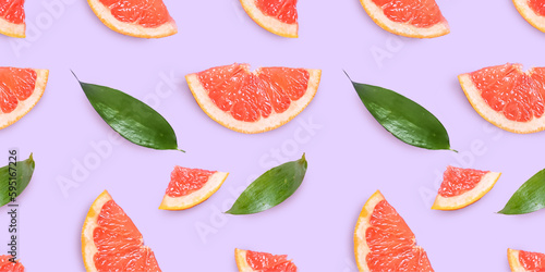 Fototapeta Naklejka Na Ścianę i Meble -  Fresh grapefruit slices on pink background