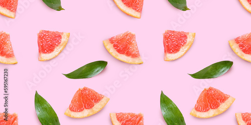 Fototapeta Naklejka Na Ścianę i Meble -  Fresh grapefruit slices on pink background