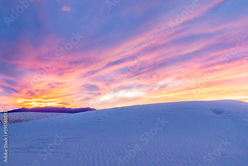 USA, New Mexico, White Sands National Monument. Sunset clouds over white sand desert.