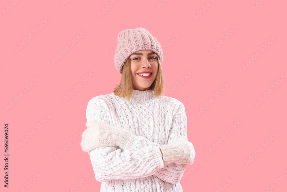 Frozen young woman in winter clothes on pink background Frozen young woman in winter clothes on pink background