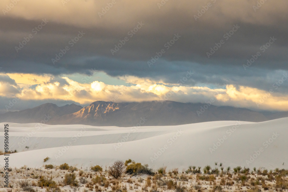 USA, New Mexico, White Sands National Monument. Sunrise clouds over desert and mountains.