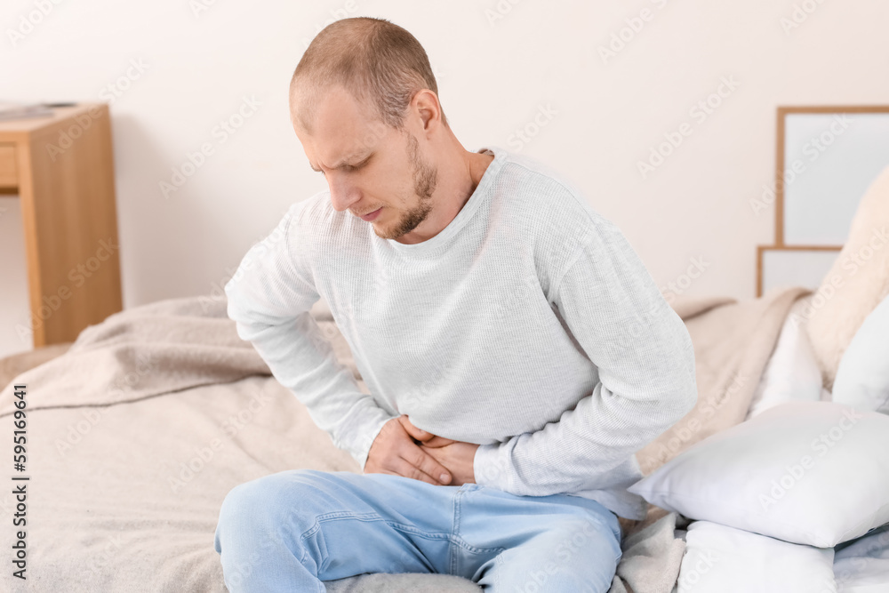 Young man with appendicitis  at home