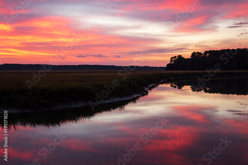 USA, Georgia. Sunrise reflections in marsh at Grimball Point.