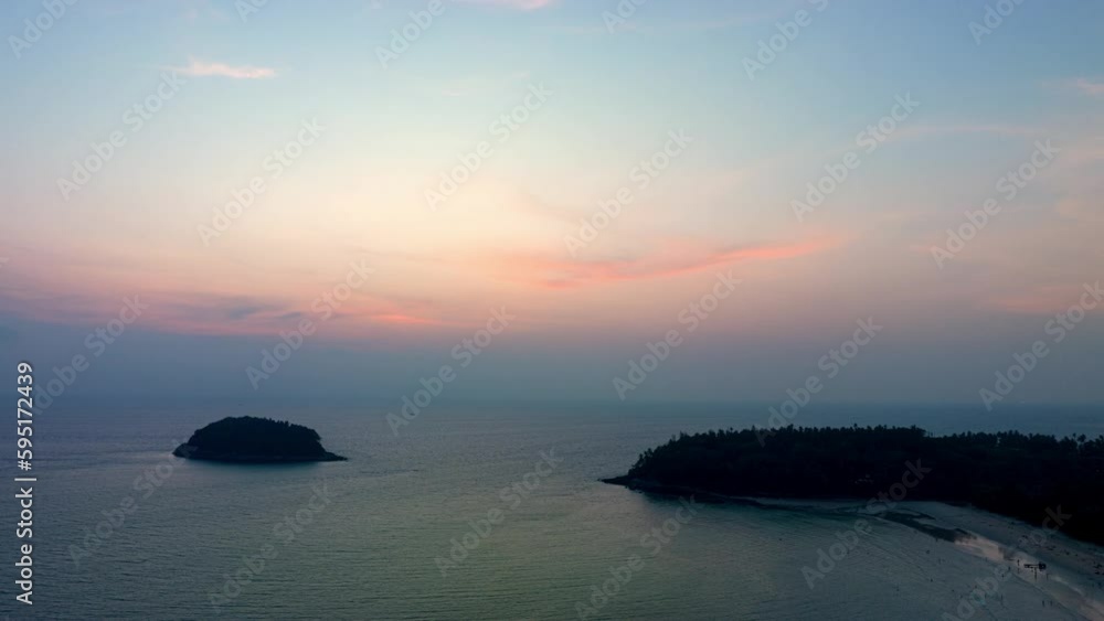 aerial hyperlapse view day to night scenery pink light shine through on sky at sunset..Scene of Colorful romantic sky in sunset or sunrise..aerial view beautiful landscape above Kata beach Phuket aerial hyperlapse view day to night scenery pink light shine through on sky at sunset..Scene of Colorful romantic sky in sunset or sunrise..aerial view beautiful landscape above Kata beach Phuket