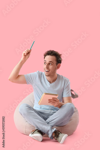 Young man with notebook hav...